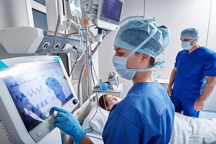 Nurses monitoring patient's vitals in the intensive care unit.