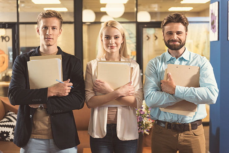 Two young men and a young woman getting ready for a job interview
